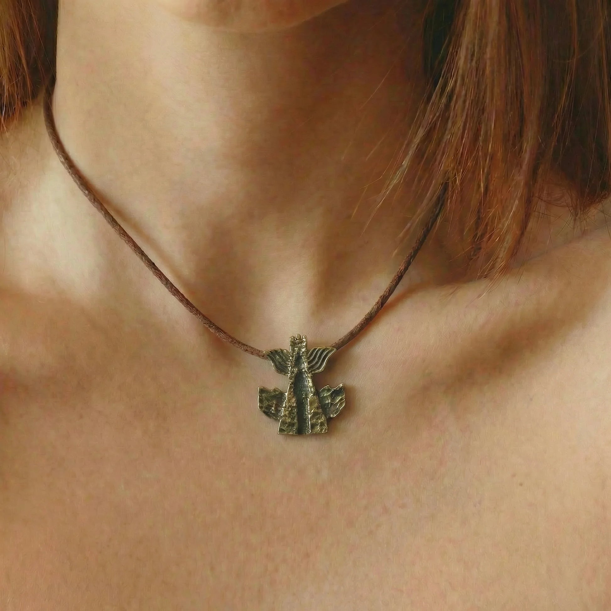Modern brass necklace featuring traditional Georgian symbolic motif
