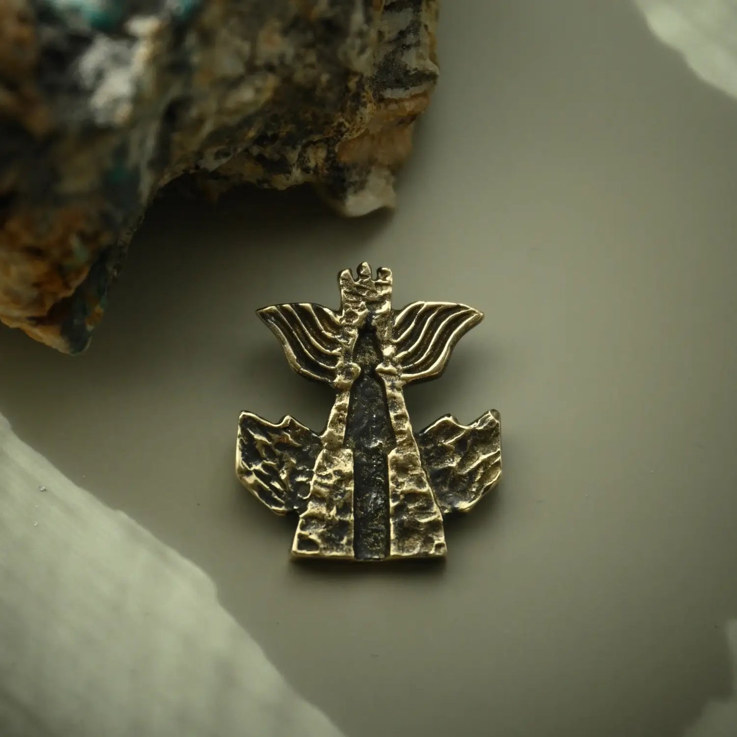 Modern brass necklace featuring traditional Georgian symbolic motif
